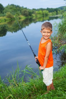 Summer vacation - Photo of little boy fishing on the river.