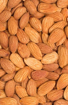 Pile of almonds close-up as background.