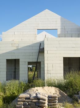 Construction of the new white brick house.