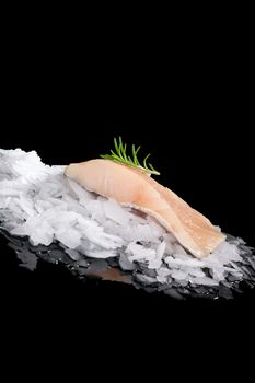 Fresh fish on crushed ice isolated on black background. Culinary fresh fish eating. 