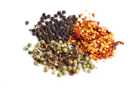 Three different typs of peppers on white background.