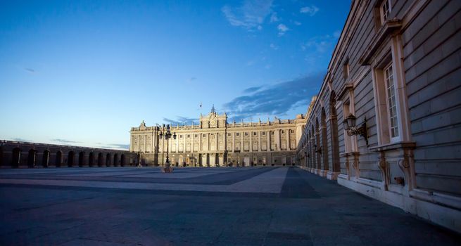 Madrid, Spain - May 6, 2012: Royal palace with tourists illuminated on spring night in Madrid, Spain