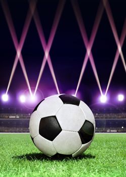 soccerball in the center of stadium during festive lighting at evening