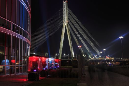 cable-stayed bridge against the backdrop of a fragment of illuminated buildings