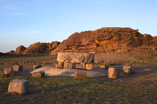 The Ceremonial Table and behind it the Rock of the Puma (Titicaca) popular archeological sites of Tiwanaku and Inca origin on Isla del Sol (Island of the Sun) in Lake Titicaca, Bolivia photographed at sunset