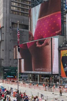 New York - Sept 2014: The giant animated billboards of Times Square light up the streets and entertain the thousands of tourists who come to visit on Sept 20, 2014 in New York, USA.