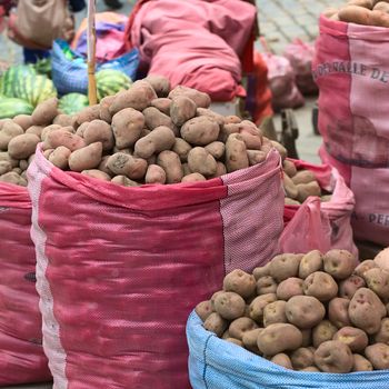 LA PAZ, BOLIVIA - NOVEMBER 10, 2014: Sacks of potatoes being sold on the roadside along Zoilo Flores street in the city center on November 10, 2014 in La Paz, Bolivia. In this area, many fruits and vegetables are being sold along the streets.
