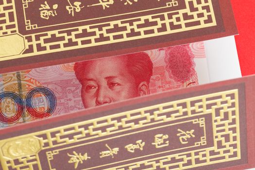 Chinese or 100 Yuan banknotes money in red envelope, as chinese new year background