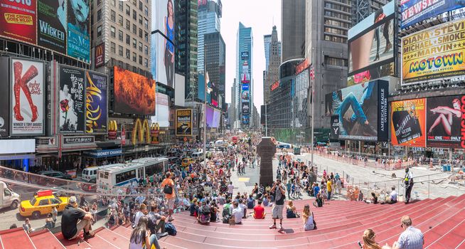 New York - Sept 2014: Tourists relax and enjoy the view of the busy streets of 42nd Street, Times Square on Sept 20, 2014 in New York, USA.