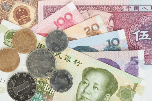 Chinese or Yuan banknotes money and coins from China's currency, close up view as background