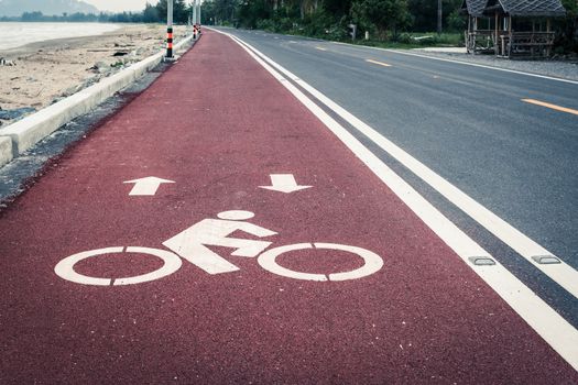 Bicycle lane or path, icon symbol on red asphalt road