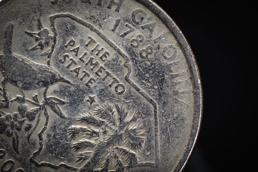 US American coin with wording "The Palmetto State" on black background