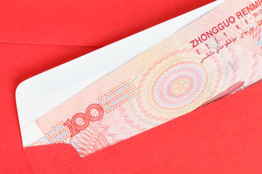 Chinese or 100 Yuan banknotes money in red envelope, as chinese new year background