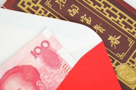 Chinese or 100 Yuan banknotes money in red envelope, as chinese new year background