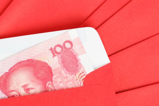 Chinese or 100 Yuan banknotes money in red envelope, as chinese new year background