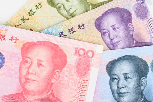 Chinese or Yuan banknotes money and coins from China's currency, close up view as background