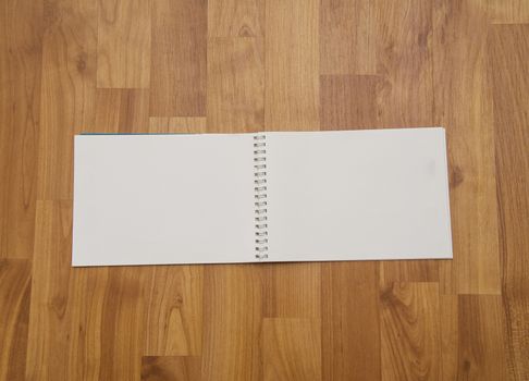 Note book on wooden background 