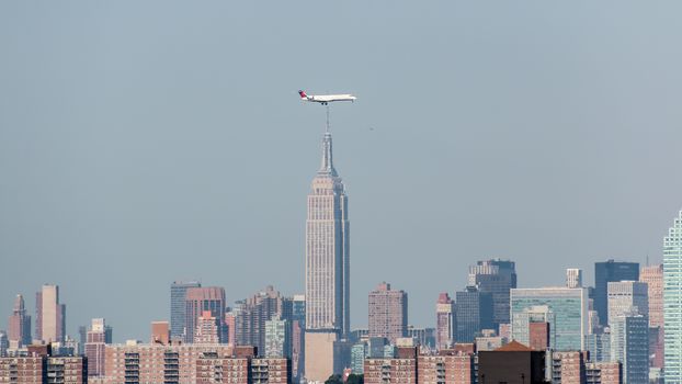 Planes landing at LaGuardia Airport fly low over the skyscrapers of New York