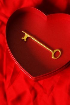 A key is placed inside a heart shaped box for the affection of loyalty.