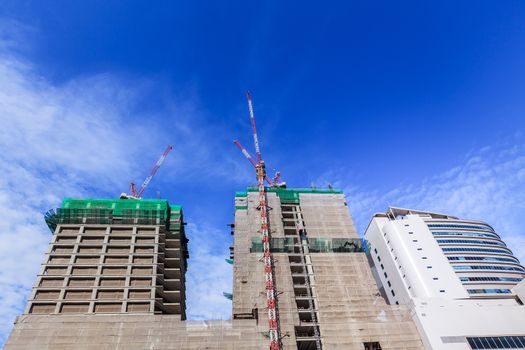 building construction site and crane with blue sky background