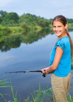 Summer vacation - Photo of cute girl fishing on the river.