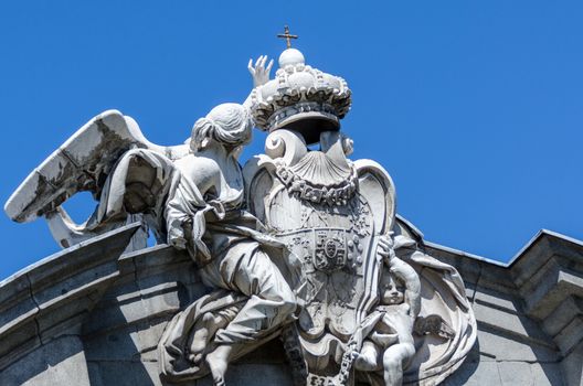 Facade of a building with sculptures on sky background in Madrid Spain