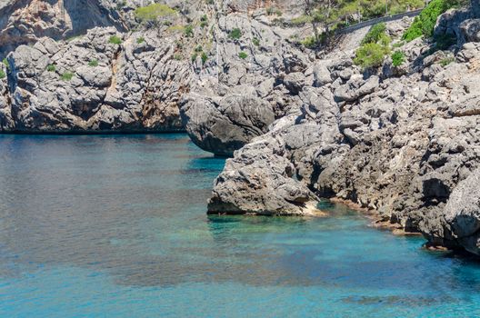 Rocky Mediterranean coast line at hot summer day in calm weather