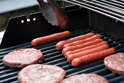 A closeup of some fresh and juicy hamburgers cooking on the grill.