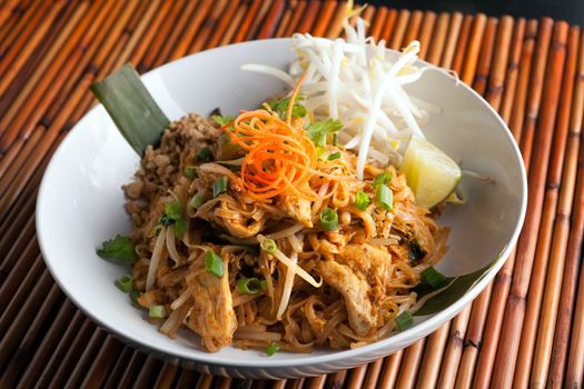 Chicken pad Thai dish of stir fried rice noodles with a contemporary presentation.