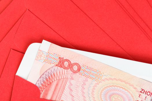 Chinese or 100 Yuan banknotes money in red envelope, as chinese new year background