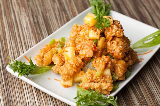 Thai fried calamari appetizer with fresh pineapple chunks.