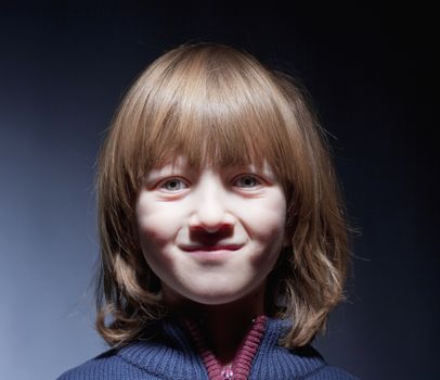 Portrait of a Boy with Blond Hair Looking Smiling