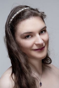 Portrait of a Young Woman with Brown Hair - Isolated on Gray