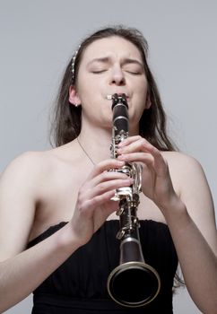 Portrait of Young Female Musician Playing Clarinet