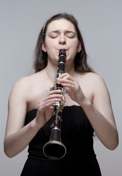 Portrait of Young Female Musician Playing Clarinet