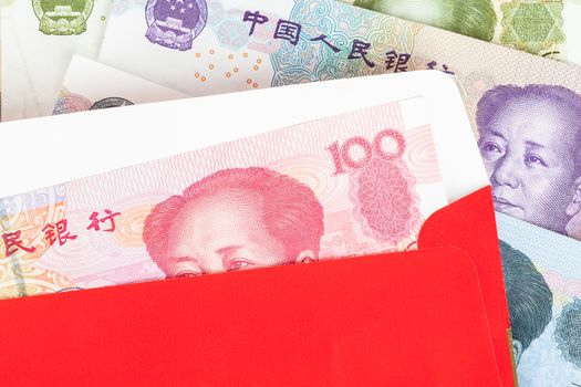 Chinese or 100 Yuan banknotes money in red envelope, as chinese new year background