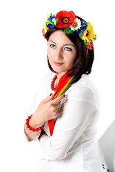 beautiful young brunette woman wearing national ukrainian clothes posing in studio on white background