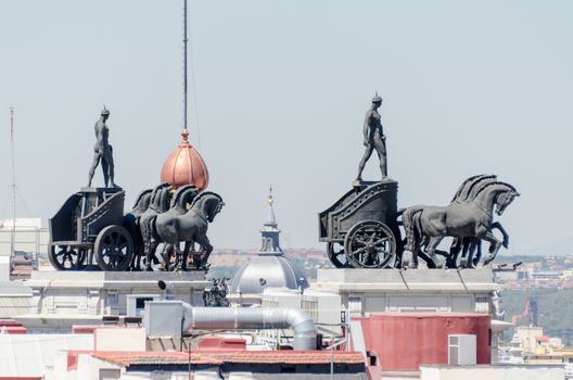 Statues on roof of Banco Bilbao Vizcaya - now part of BBVA (architect Ricardo Bastida y Bilbao, built from 1920 to 1923) is a building located at Calle de Alcala, 16, in Madrid, Spain. Quadriga on Bank.