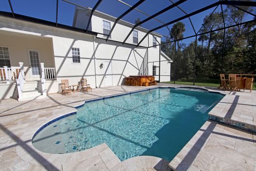 A swimming pool and hot tub at a large home