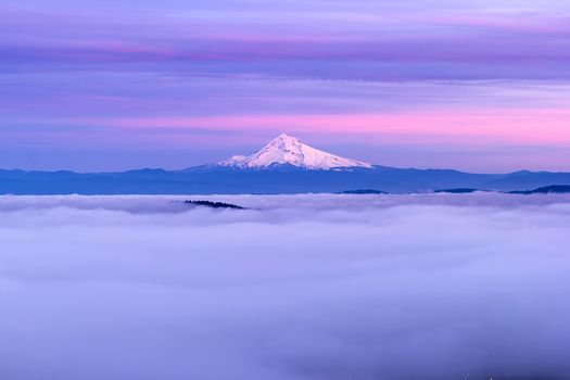 Mt Hood and Low Foggy Clouds over City of Portland in Oregon at Sunset