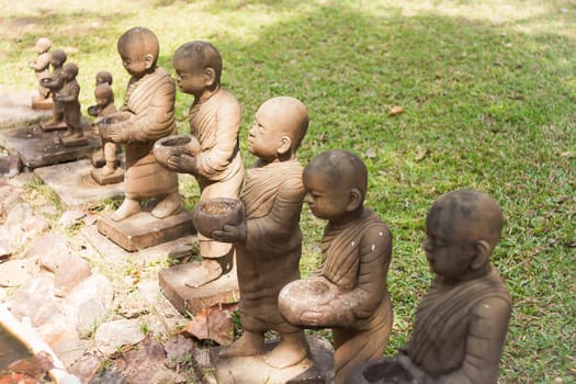 Little monk clay doll decorated in garden, stock photo