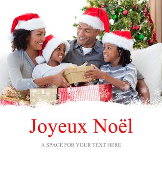 Family celebrating Christmas at home against joyeux noel