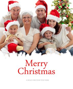 Children sitting with their family holding Christmas boots against merry christmas