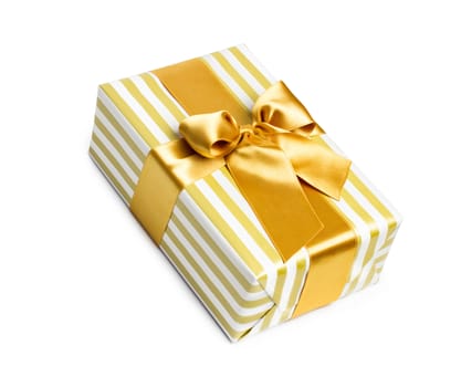 Gift box in gold duo tone with golden satin ribbon and bow isolated over white background.