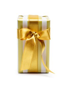 Gift box in gold duo tone with golden satin ribbon and bow isolated over white background.