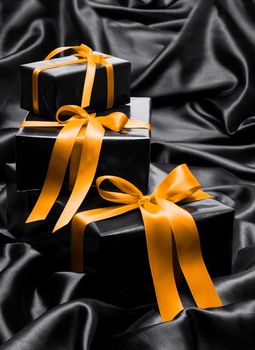 Black gift boxe with yellow satin ribbons and bows