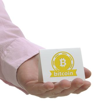 Business man holding bitcoin sign on hand