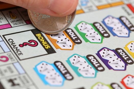 Coquitlam BC Canada - June 15, 2014 : Woman scratching lottery tickets. The British Columbia Lottery Corporation has provided government sanctioned lottery games in British Columbia since 1985. 