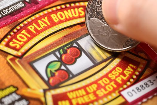 Coquitlam BC Canada - February 05, 2015 : Woman scratching lottery tickets. The British Columbia Lottery Corporation has provided government sanctioned lottery games in British Columbia since 1985. 