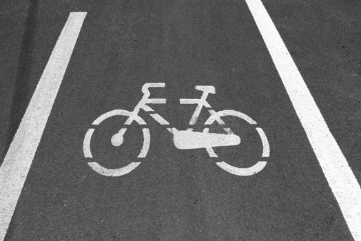 White markings representing a bicycle in a route reserved for bikes